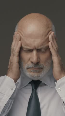 Exhausted stressed businessman having a bad headache