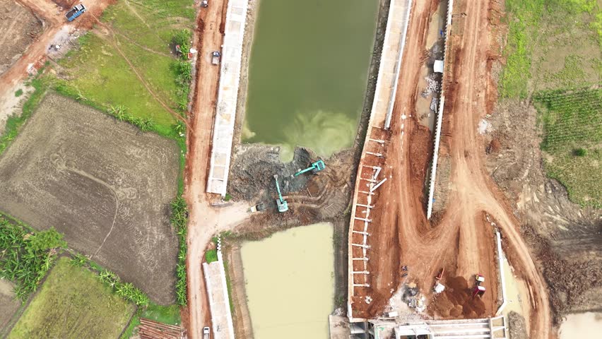 Two Escavators working inside Dam Contruction
