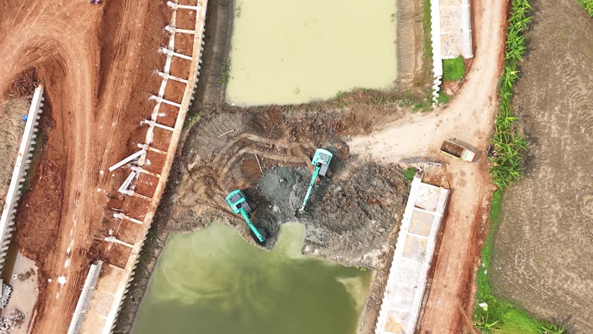 Two Escavators working inside Dam Contruction
