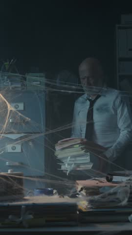 Businessman searching for files in his abandoned office