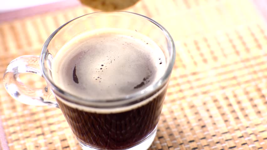 Dipping Cookies In Coffee Cup. Crispy Pastry. Crispy Biscuit cantuccini At Morning. Pouring Sweet Cookies In Coffee Mug. Cozy enjoying espresso coffee morning at home. dipping cookie into hot drinks.