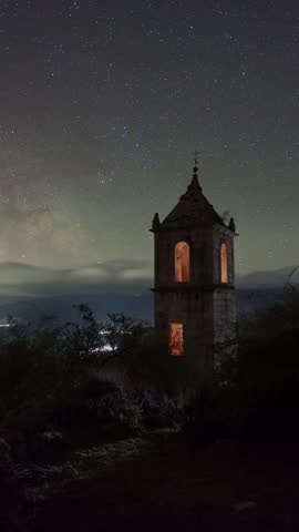 Timelapse of the bell tower at the ruins of Nuestra Señora del Risco Monastery in Ávila, with the galactic center of the Milky Way moving across the night sky behind it