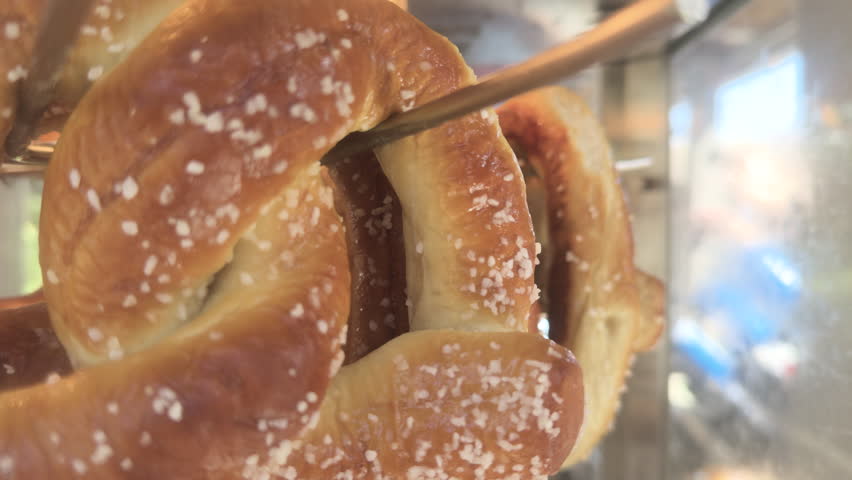 Fresh soft pretzel spinning in display for sale 4k