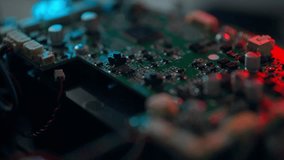 A close-up view of a circuit board filled with various electronic components, including capacitors and connectors. The low lighting highlights the intricate details of the board and its wiring - Powered by Shutterstock - Get 15% off with code: PIKWIZARD15