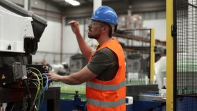 Engineer wearing safety glasses and a high visibility vest operates robotic machinery in a modern factory, highlighting the integration of human expertise and automation in industrial processes - Powered by Shutterstock - Get 15% off with code: PIKWIZARD15