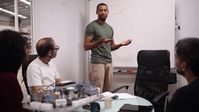 Multiracial team of engineers collaborates on a robotics project, engaging in a productive discussion in a modern factory setting, fostering innovation and teamwork - Powered by Shutterstock - Get 15% off with code: PIKWIZARD15