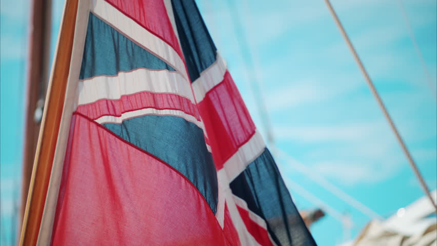 The Red Ensign British marine flag on a boat docked in the port of Cannes, France
