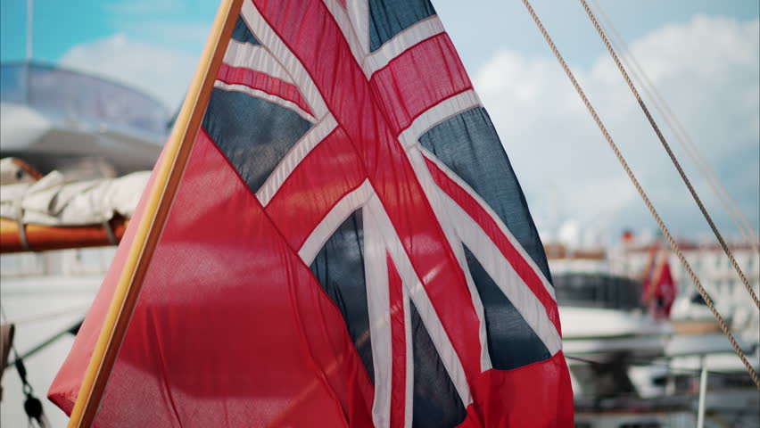 The Red Ensign British marine flag on a boat docked in the port of Cannes, France