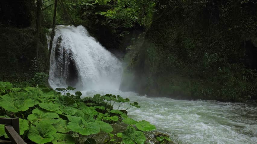 Terni, Italy. Cascata delle Marmore. Waterfall along the trail in the Marmore Falls park. Lush vegetation with water mist and a torrent with strong flow. Slow motion 4K video.