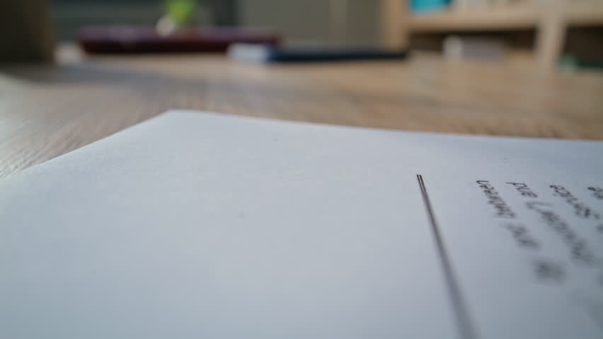 Closeup document on office desk at organized workspace. Legal business contract lying on wooden desk professional work environment. Modern empty workplace for handling official paperwork dolly shot.