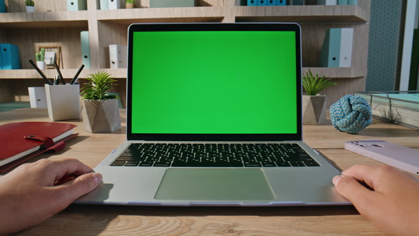 Man looking green screen laptop video at company workplace closeup zoom in. Unknown male freelancer watching webinar at chroma key computer. Businessman browsing online application at mockup device.