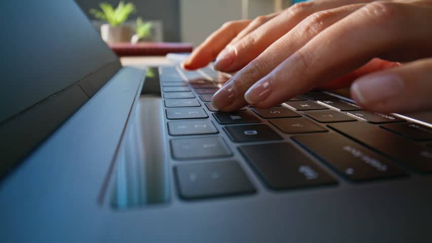 Macro shot fingers typing laptop in office environment. Unknown businesswoman hands pressing keys modern computer closeup dolly shot. Professional female freelancer working remotely at home workplace.