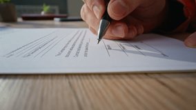 Closeup hand signing document in professional office. Unrecognizable businessman putting signature on business contract on workspace desk. Detailed shot ceo confirmed official deal doing paperwork - Powered by Shutterstock - Get 15% off with code: PIKWIZARD15