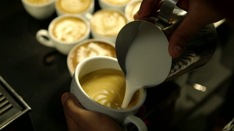 Barista makes pattern in coffee    