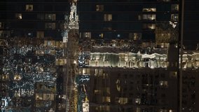 Reflected city lights gradually come into focus on the colorful windows of apartment buildings, as the vibrant hues of neon signs and streetlights create a dynamic, glowing display against the sleek g - Powered by Shutterstock - Get 15% off with code: PIKWIZARD15