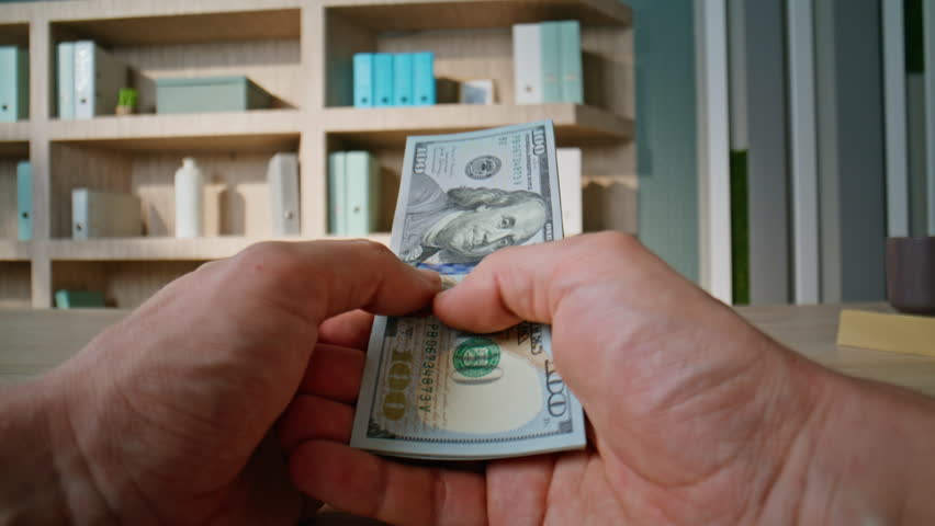 Businessman hands counting usa banknotes in office closeup. Unknown rich man holding dollars cash for business deal in professional workspace. Entrepreneur calculating money for financial investment.