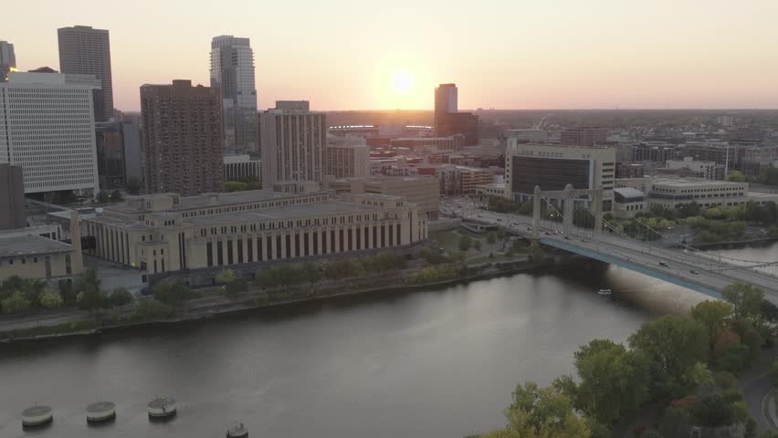 Aerial pull back shot of Hennepin avenue bridge over Mississippi River during sunset in Minnesota, USA. Minneapolis cityscape.