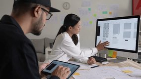 UX UI designers discussing and brainstorming on wireframes for a website and mobile app prototype, in the concept of website and mobile application design concept. - Powered by Shutterstock - Get 15% off with code: PIKWIZARD15