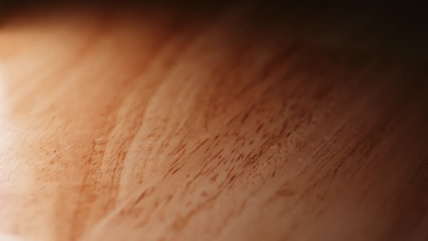 Close-up of U.S. coins in falling onto a wooden surface