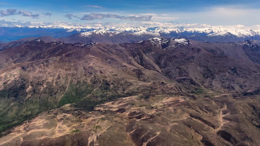 Picturesque southern alps mountain range in Queenstown, New Zealand, wide aerial