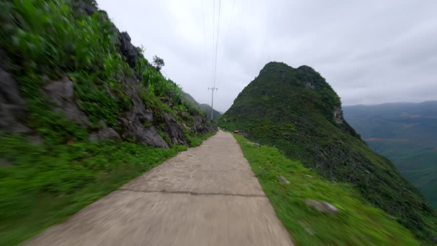 POV Of Scooter Riding On Dangerous Narrow Road At Ha Giang Loop, Fell Down The Roadside In Vietnam. tracking shot