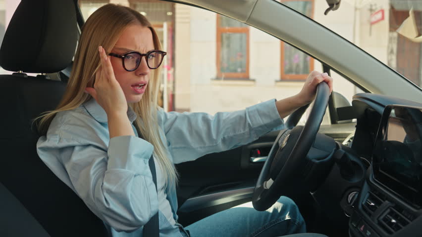 Caucasian woman female girl businesswoman driver car automobile holding head temples migraine headache city noise suffer sick suffering tired unhealthy tension owner transport driving road steering