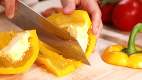 Hands cutting yellow peppers on a wooden board - Powered by Shutterstock - Get 15% off with code: PIKWIZARD15