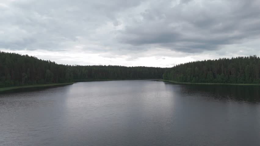 Landcape of lake and forest around with cloudy sky