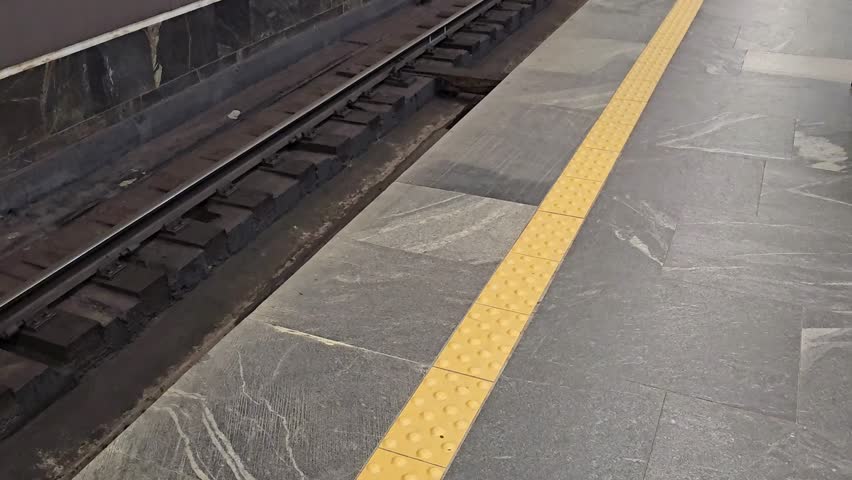 Tracks and platform details at a subway station in the city during daytime