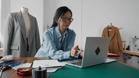 Japanese fashion designer woman sketching gorgeous dress on paper, portrait. Aged Asian lady working in atelier studio, Chinese dressmaker creating tailor-made clothing, creativity work and hobby - Powered by Shutterstock - Get 15% off with code: PIKWIZARD15