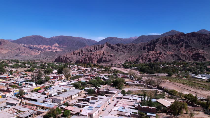 Aerial View Of Tilcara, Argentina, Showcasing Vibrant Houses And A Dry Lake Under Bright Summer Sunlight. The Drone Captures Stunning Mountains In The Background, Evoking Tranquility And Beauty.