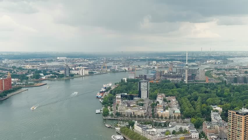 Dolly zoom. Rotterdam, Netherlands. View of the port. River Nieuwe Maas. Summer day, Rainy clouds, Aerial View
