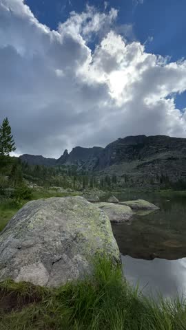 Cloudy sunny day mountain landscape time lapse. Clouds moving fast High quality FullHD footage