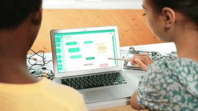 Laptop display coding system while student studying writing engineering code. Back view of diverse student learning programming system while pointing at screen at STEM technology class. Edification - Powered by Shutterstock - Get 15% off with code: PIKWIZARD15