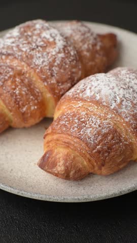 Fresh crispy sweet croissant with chocolate filling as part of a hearty breakfast