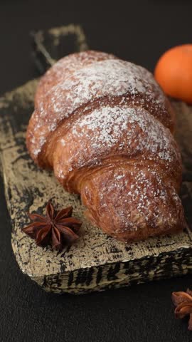 Fresh crispy sweet croissant with chocolate filling as part of a hearty breakfast