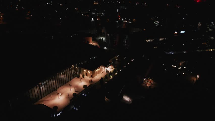 Palas development lit rooftop at night, urban Romania