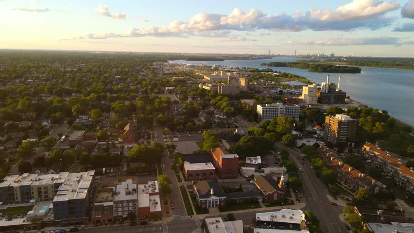 Downtown Wyandotte with residential and industrial areas by Detroit River on sunlight evening
