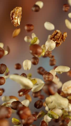 Super Slow Motion Shot of Flying and Rotating Various Nuts After Being Exploded at 1000 fps.