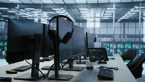 Electronic devices in empty data center establishment monitoring hardware energy consumption. PC monitors on desk used for checking potential system failures in server room, handheld camera shot - Powered by Shutterstock - Get 15% off with code: PIKWIZARD15