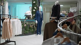Asian woman helping wheelchair user choose the best clothing items at a mall store, browsing for the new collection of designer merchandise. Diverse customers on a shopping spree. Camera B. - Powered by Shutterstock - Get 15% off with code: PIKWIZARD15
