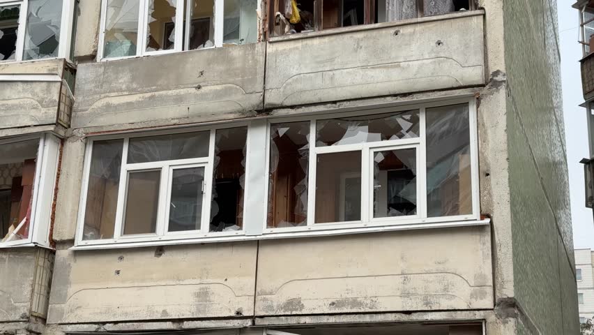 Consequences of a house explosion
after a missile strike. Missile strike. Burnt building, Rocket explosion, Building, rescuers.