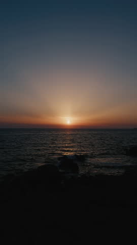 Beautiful sunset on the ocean vertical view