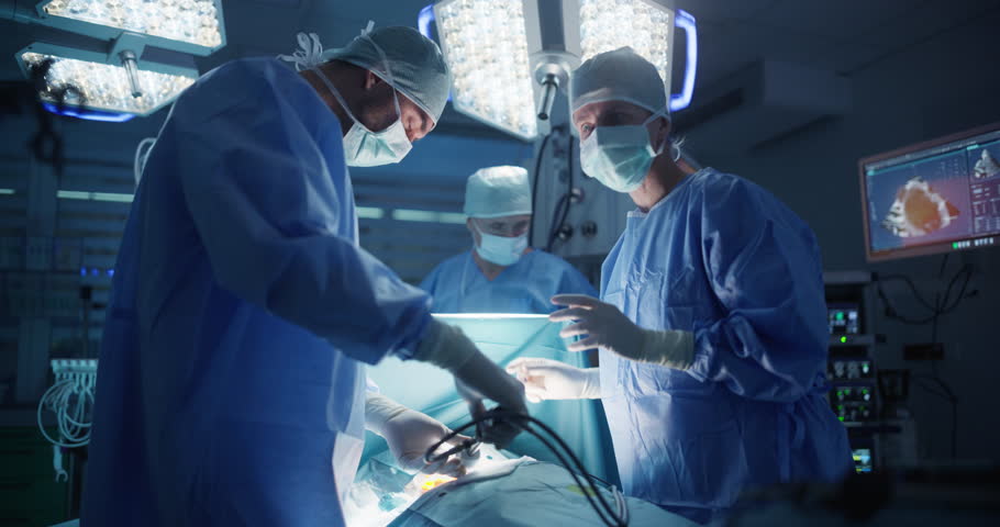 Deep in the Process of an Emergency Surgery, Diverse Team of Healthcare Professionals Navigating Each Stage of the Operation with Extreme Concentration, Uniting Their Skills to Perform the Procedure