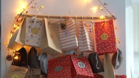 The snow globe, held in the palm, in front of the Christmas advent calendar. Colored bags and lights can be seen in the blurry background - Powered by Shutterstock - Get 15% off with code: PIKWIZARD15