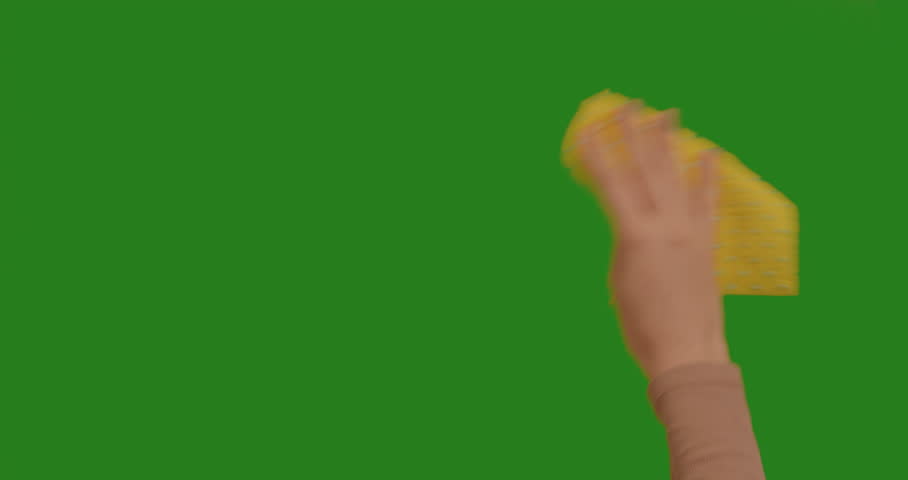 Woman hand wiping with a cloth on chroma key green screen background. Wiping, cleaning the space. Chroma Key Green Background, like using a touchscreen.