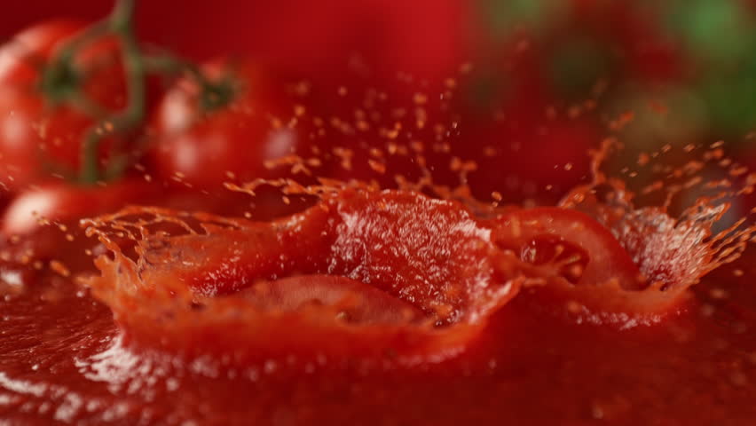 Super Slow Motion Shot of Fresh Tomato Falling and Splashing into Sauce at 1000fps.