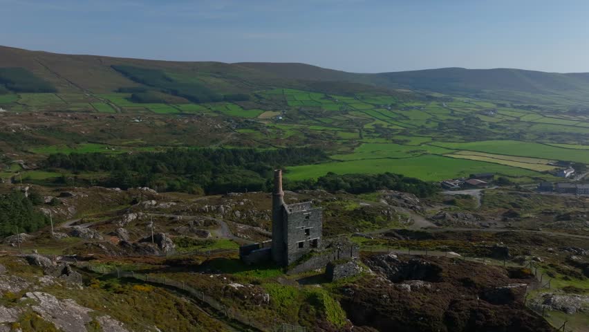 Copper Mine, Allihies, County Cork, Ireland, September 2024. Drone orbits counter clockwise around the historic ruined structure surrounded by the rugged mountainous landscape.