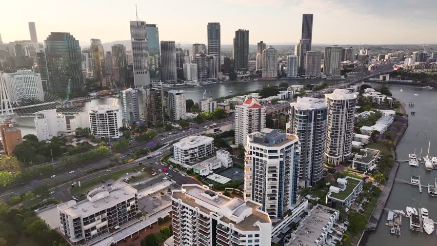 Beautiful cityscape of Brisbane over Kangaroo Point with residential buildings. Aerial sunset.