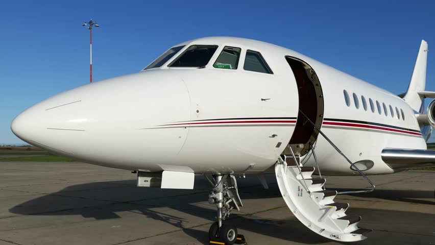 business jet parked airport deployed stairs sunny weather enhance luxurious close up panning shot inverness aviation scene luxury setting regional highlands backdrop